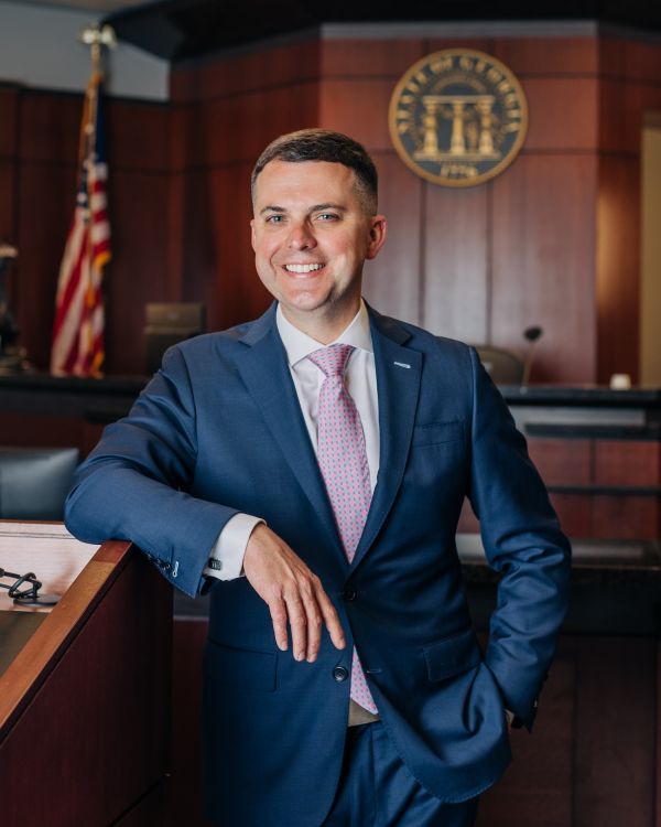 David Willingham in a suit smiling in a courtroom